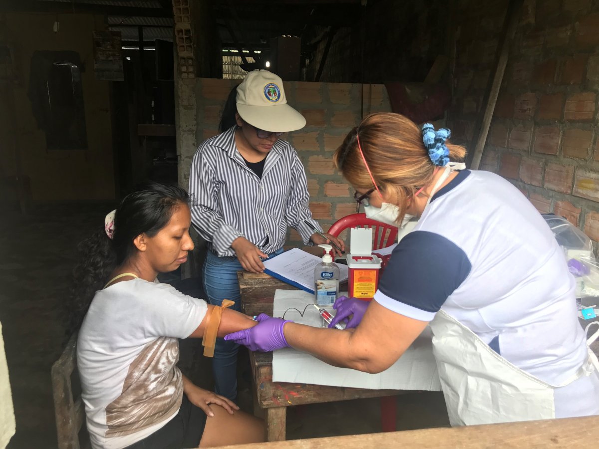 NAMRU-6 staff pose for a photo while performing malaria microscopy in the NAMRU-6 Iquitos laboratory. (U.S. Navy photo by Greys Braga/Released)